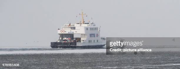 March 2018, Germany, Schaprode: The ferry "Vitte" driving on the ice covered Bodden near the island Ruegen. The Hiddensee shipping company is driving...