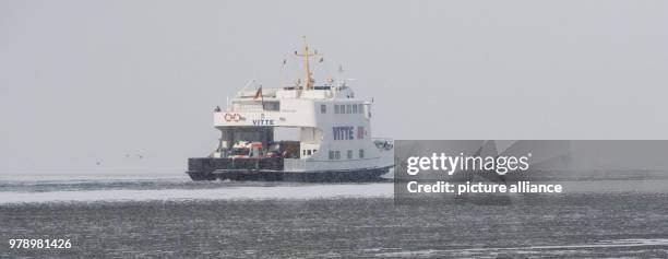 March 2018, Germany, Schaprode: The ferry "Vitte" driving on the ice covered Bodden near the island Ruegen. The Hiddensee shipping company is driving...