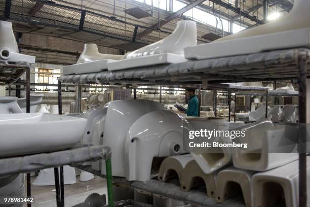 An employee checks sanitaryware parts requiring repairs at the HSIL Ltd. Factory in Bahadurgarh, Haryana, India, on Monday, June 11, 2018. Indian...