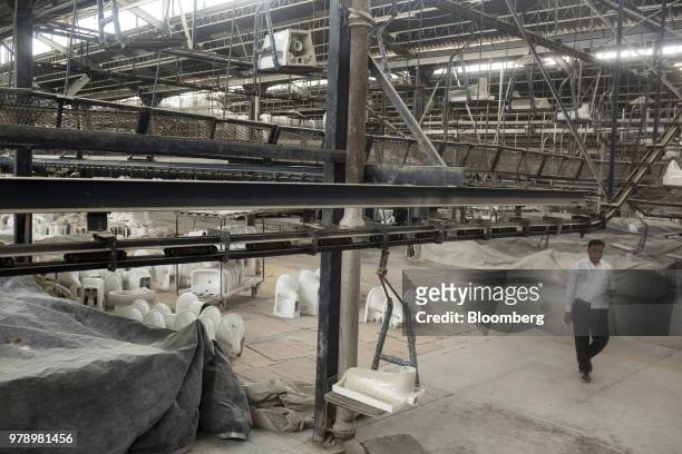 Squat-toilet is moved on a conveyor at the HSIL Ltd. Factory in Bahadurgarh, Haryana, India, on Monday, June 11, 2018. Indian Prime Minister Narendra...