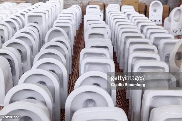 Hindware toilet bowls sit ready to be packed at the HSIL Ltd. Factory in Bahadurgarh, Haryana, India, on Monday, June 11, 2018. Indian Prime Minister...
