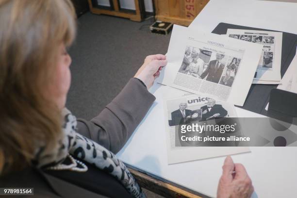 February 2018, Germany, Hanover: The widow Gundula Fuchsberger looks at newpaper reports at the exhibition about her deceased husband Joachim...