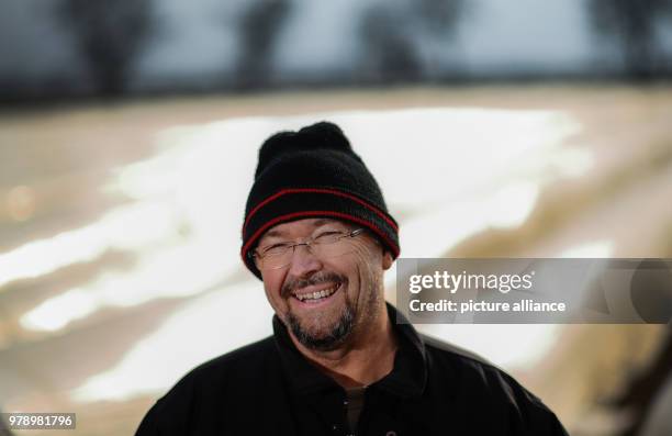 March 2018, Germany, Buerstadt: Farmer Andreas List stands in front of the fields of asparagus, which are covered with tarpaulins. The luxury...