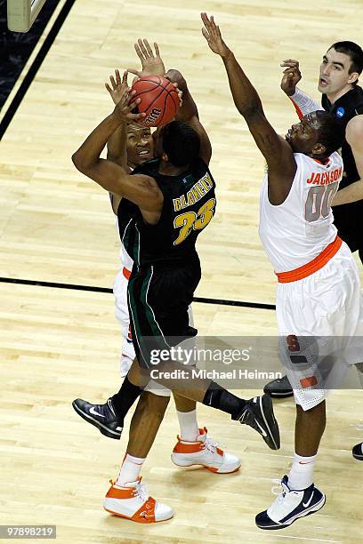 Marqus Blakely of the Vermont Catamounts goes to the hoop against Wes Johnson of the Syracuse Orange during the first round of the 2010 NCAA men's...