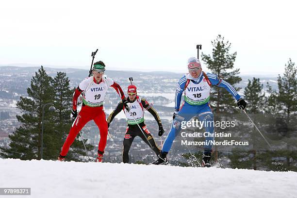 Tobias Eberhard of Austria competes with Arnd Peiffer of Germany and Ivan Tcherezov of Russia during the men's pursuit in the E.On Ruhrgas IBU...