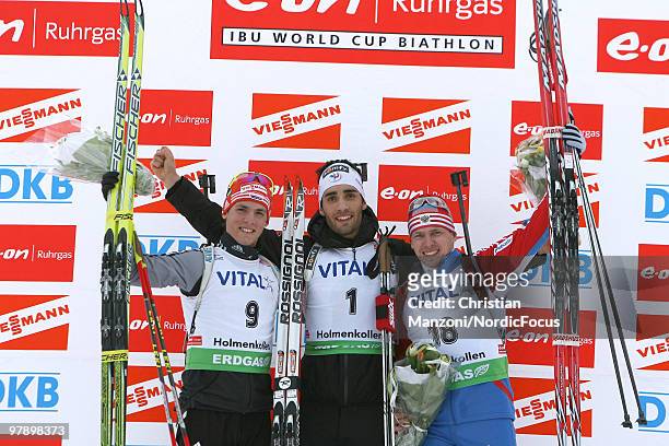 Simon Schempp of Germany celebrates with Martin Fourcade of France and Ivan Tcherezov of Russia during the men's pursuit in the E.On Ruhrgas IBU...