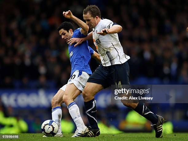 Mikel Arteta of Everton tackles Kevin Davies of Bolton Wanderers during the Barclays Premier League match between Everton and Bolton Wanderers at...