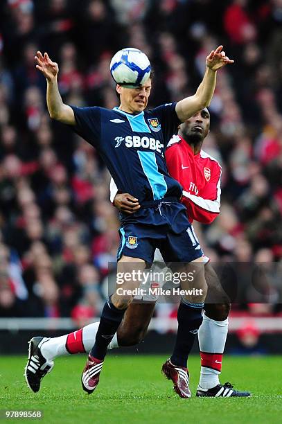 Sol Campbell of Arsenal challenges Guillermo Franco of West Ham United during the Barclays Premier League match between Arsenal and West Ham United...