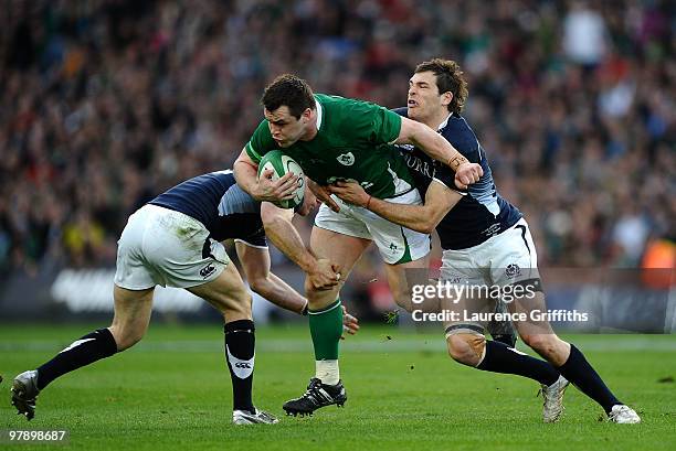 Cian Healy of Ireland is tackled by Sean Lamont and Graeme Morrison of Scotland during the RBS Six Nations match between Ireland and Scotland at...