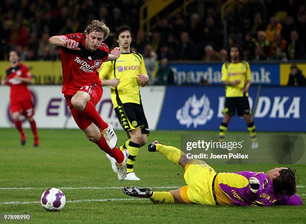 Roman Weidenfeller of Dortmund and Stefan Kiessling of Leverkusen compete for the ball during the Bundesliga match between Borussia Dortmund and...