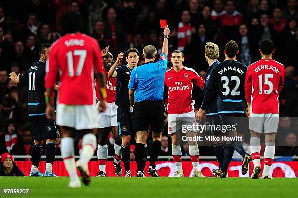 Referee Martin Atkinson shows Thomas Vermaelen of Arsenal the red card during the Barclays Premier League match between Arsenal and West Ham United...