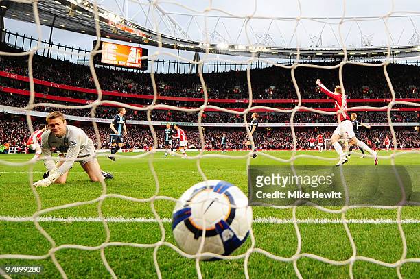 Denilson of Arsenal celebrates scoring the opening goal as goalkeeper Robert Green of West Ham United looks into his net during the Barclays Premier...