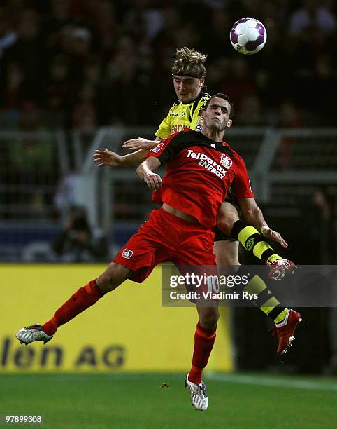 Renato Augusto of Leverkusen and Marcel Schmelzer of Dortmund vie for a header during the Bundesliga match between Borussia Dortmund and Bayer...