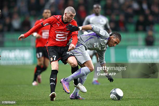 Rennes' midfielder Jerome Leroy vies with Toulouse's defender Etienne Capoue during the French L1 football match Rennes vs Toulouse, on March 20,...