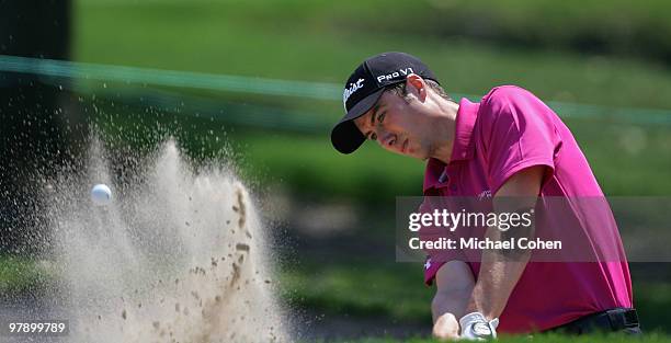 Ross Fisher of England hits a bunker shot on the first hole during the third round of the Transitions Championship at the Innisbrook Resort and Golf...