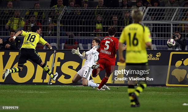 Lucas Barrios of Dortmund scores his team's second goal against Rene Adler of Leverkusen during the Bundesliga match between Borussia Dortmund and...