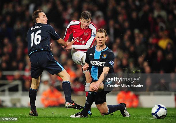 Andrei Arshavin of Arsenal has a shot blocked by Mark Noble and Jonathan Spector of West Ham United during the Barclays Premier League match between...