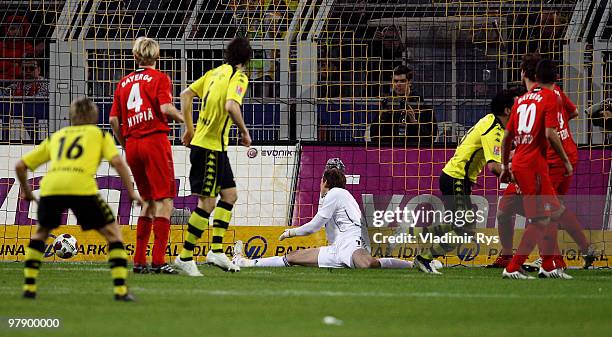 Lucas Barrios of Dortmund scores his team's first goal against Rene Adler of Leverkusen during the Bundesliga match between Borussia Dortmund and...
