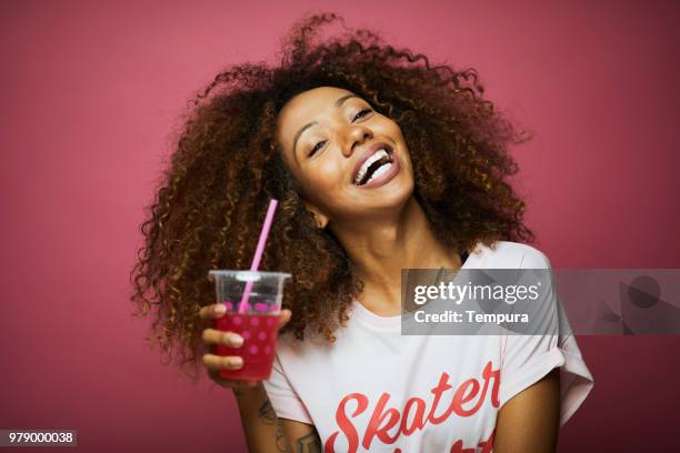 beautiful young woman with afro, summer time. - pink drink stock pictures, royalty-free photos & images