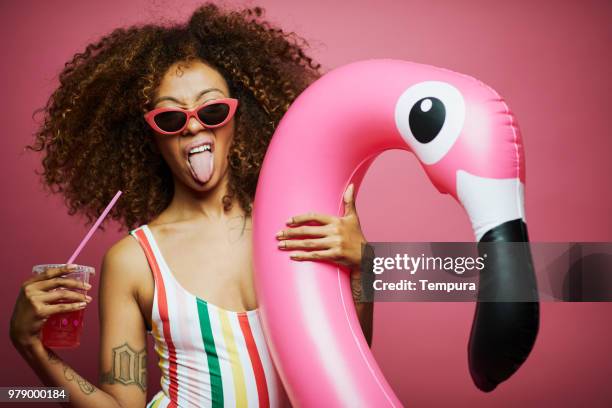 beautiful young woman with afro, summer time. - pink tube stock pictures, royalty-free photos & images