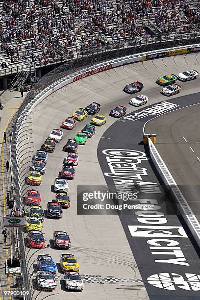 Brad Keselowski, driver of the Discount Tire Dodge, and Joey Logano, driver of the GameStop Toyota, lead thei field to the green flag to start the...