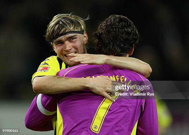 Marcel Schmelzer celebrates with his team mate Roman Weidenfeller of Dortmund after the final whistle of the Bundesliga match between Borussia...