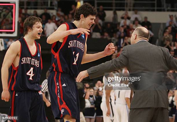 Clint Stiendl and Matthew Dellavedova of the Saint Mary's Gaels celebrate with head coach Randy Bennett after they defeated the Villanova Wildcats...