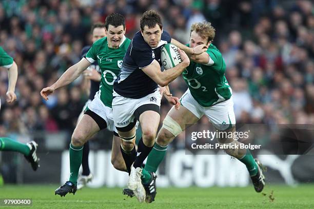 Sean Lamont of Scotland is tackled by Jonathan Sexton and Stephen Ferris of Ireland during the RBS Six Nations match between Ireland and Scotland at...