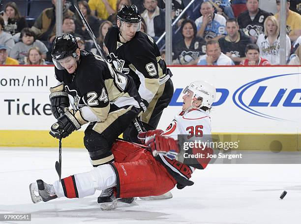 Jussi Jokinen of the Carolina Hurricanes collides with Matt Cooke and Pascal Dupuis of the Pittsburgh Penguins on March 20, 2010 at Mellon Arena in...