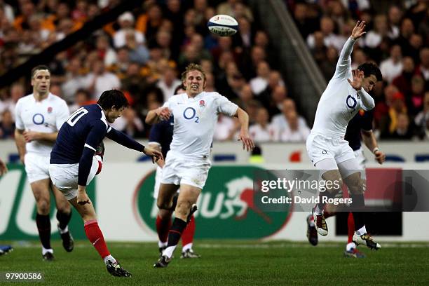 Francois Trinh-Duc of France kicks a drop goal as Danny Care of England closes in during the RBS Six Nations Championship match between France and...