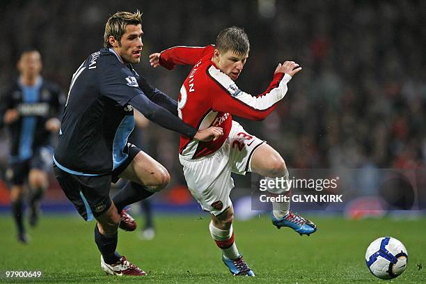 Arsenal's Russian player Andrey Arshavin vies with West Ham's Swiss player Valon Behrami during the English Premier League football match between...
