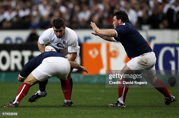 Nick Easter of England is challenged by Nicolas Mas and Thomas Domingo of France during the RBS Six Nations Championship match between France and...