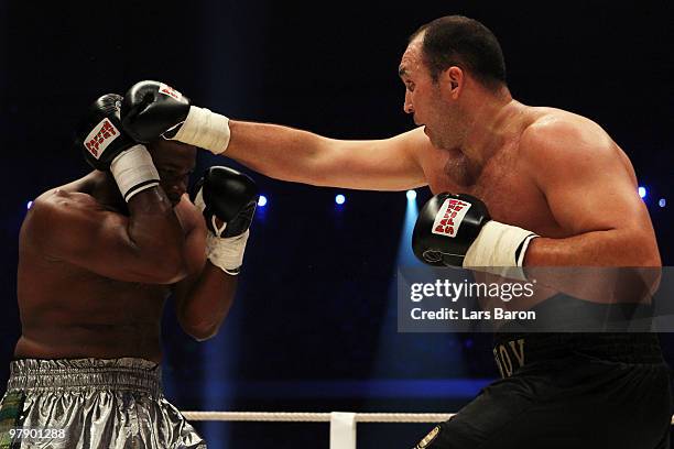 Alexander Ustinov of Belarus lands a punch on Ed Mahone of USA during their Heavyweight fight prior to the WBO Heavyweight World Championship fight...