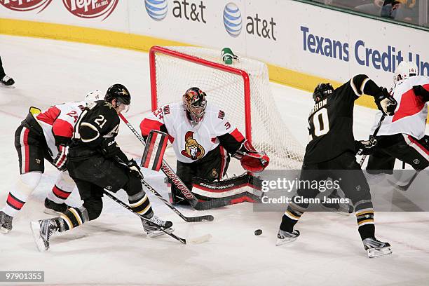 Pascal Leclaire of the Ottawa Senators tries to make a save against Brenden Morrow and Loui Eriksson of the Dallas Stars on March 20, 2010 at the...