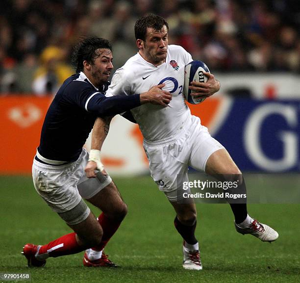 Mark Cueto of England is tackled by Clement Poitrenaud of France during the RBS Six Nations Championship match between France and England at the...