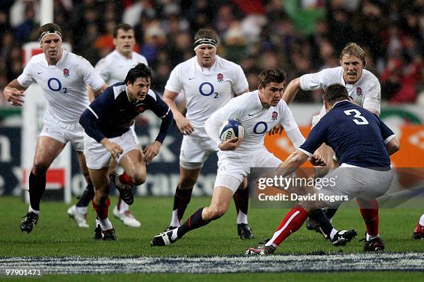 Toby Flood of England is challenged by Nicolas Mas of France during the RBS Six Nations Championship match between France and England at the Stade de...