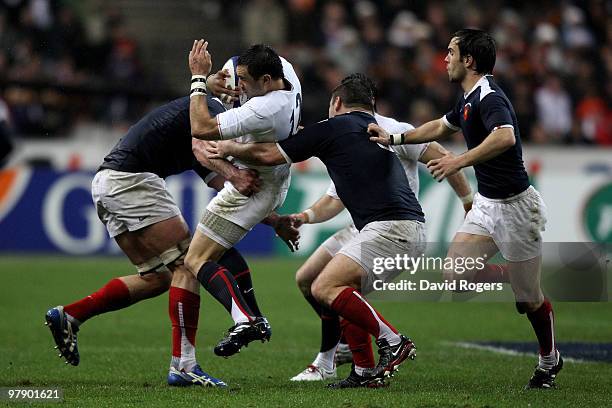 Riki Flutey of England is wrapped up by the French defence during the RBS Six Nations Championship match between France and England at the Stade de...