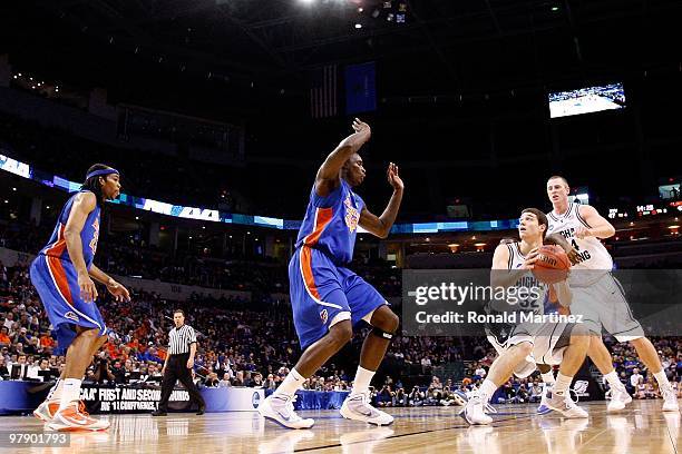 Jimmer Fredette of the BYU Cougars looks to shoot the ball against Vernon Macklin of the Florida Gators during the first round of the 2010 NCAA men�s...