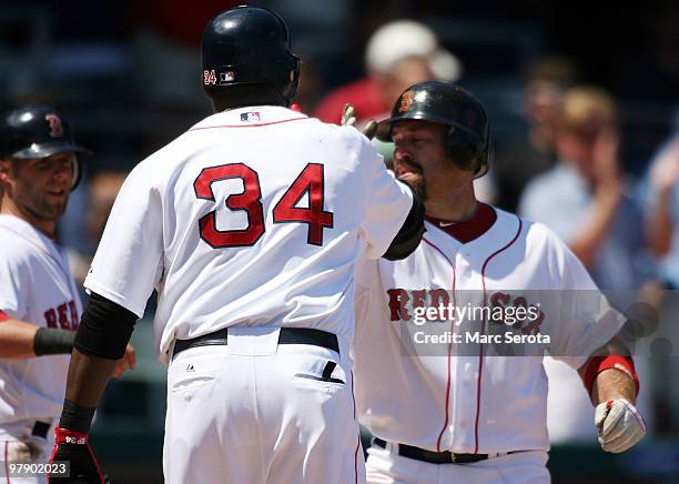 Kevin Youkilis of the Boston Red Sox celebrates a two run home run against the Baltimore Orioles with teammate David Ortiz on March 20, 2010 at City...