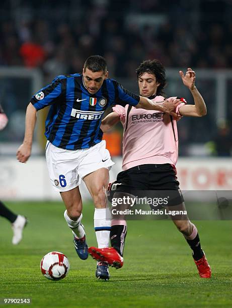Javier Pastore of US Citta di Palermo battles for the ball with Lucio Da Silva Ferreira of FC Internazionale Milano during the Serie A match between...
