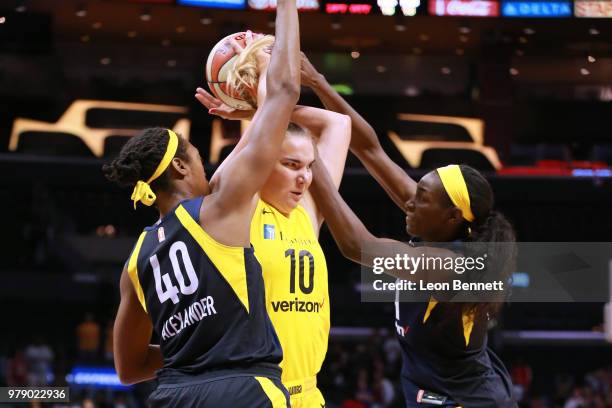 Maria Vadeeva of the Los Angeles Sparks handles the ball against Kayla Alexander and Asia Taylor of the Indiana Fever during a WNBA basketball game...