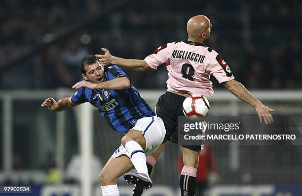 Inter Milan's Serbian midfielder Dejan Stankovic heads the ball with Palermo's defender Giulio Migliaccio during their Serie A football match at...