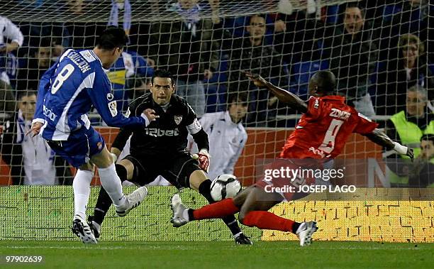 Espanyol's Jose Maria Callejon Bueno misses a goal against Sevilla's goalkeeper Andres Palop and Ivory Coast midfielder Didier Zokora during a...