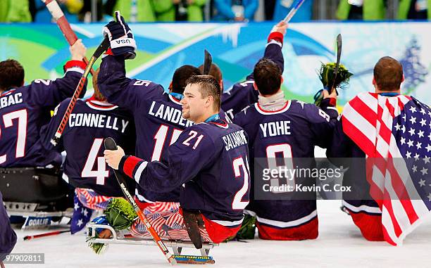 Alexi Salamone of the United States and teammates celebrate defeating Japan 2-0 during the Ice Sledge Hockey Gold Medal Game between the United...