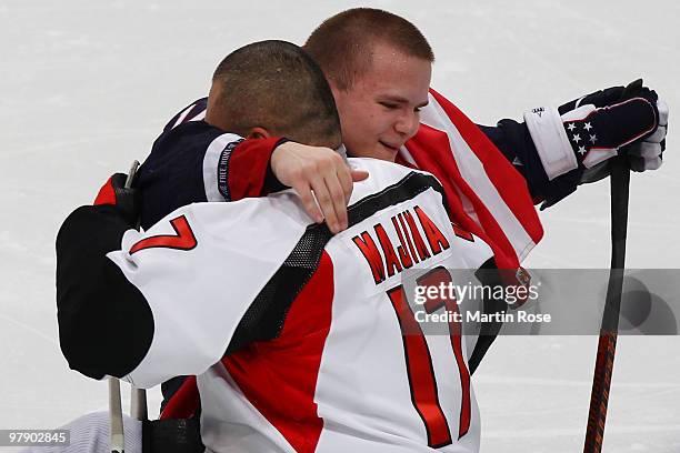 Josh Pauls of the United States is congratulated by Makoto Majima of Japan on their 2-0 victory during the Ice Sledge Hockey Gold Medal Game on day...