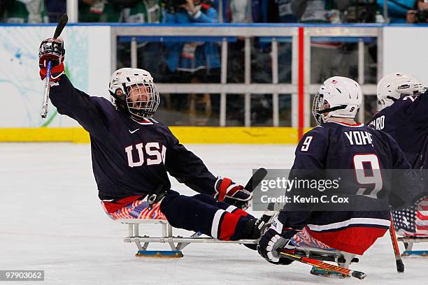 Taylor Lipsett of the United States celebrates scoring the second goal against Japan with Andy Yohe during the Ice Sledge Hockey Gold Medal Game...