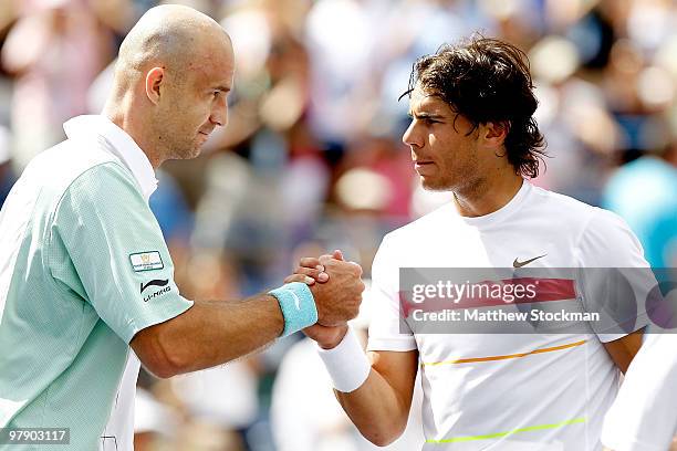 Ivan Ljubicic of Croatia is congratulated at the net by Rafael Nadal of Spain after their match during the semifinals of the BNP Paribas Open on...