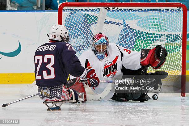 Goalkeeper Mitsuru Nagase of Japan saves a shot on goal by Joe Howard of the United States during the Ice Sledge Hockey Gold Medal Game between the...