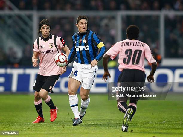 Javier Zanetti of FC Internazionale Milano in action against Javier Pastore of US Citta' di Palermo and Fabio Simplico during the Serie A match...