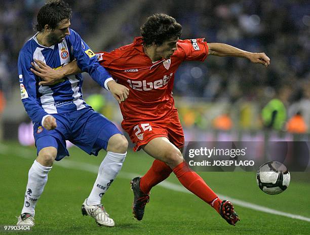 Sevilla's Argentinian midfielder Diego Perotti vies for the ball with Espanyol's Nicolas Pareja of Argentina during their Spanish League football...